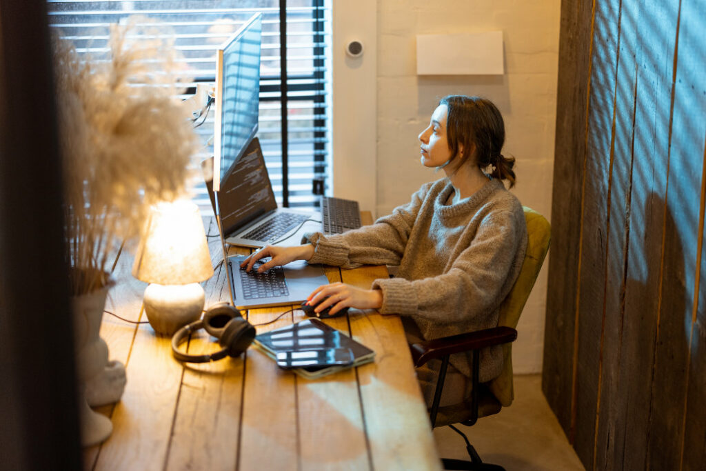 A developer sitting at her computer and working